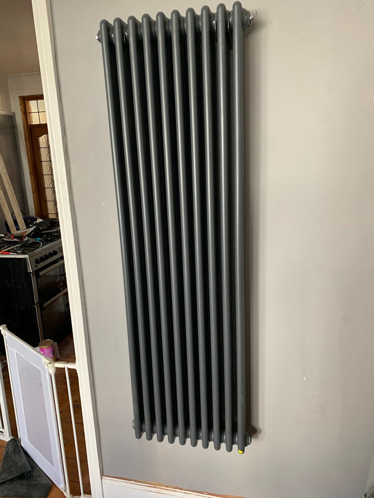 Modern vertical radiator installed on wall