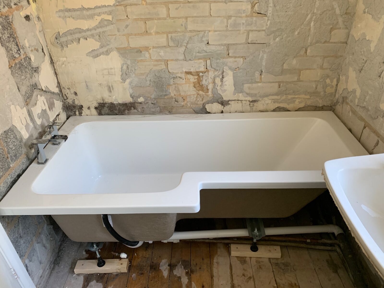 New bath and plumbing installed during the bathroom refurbishment