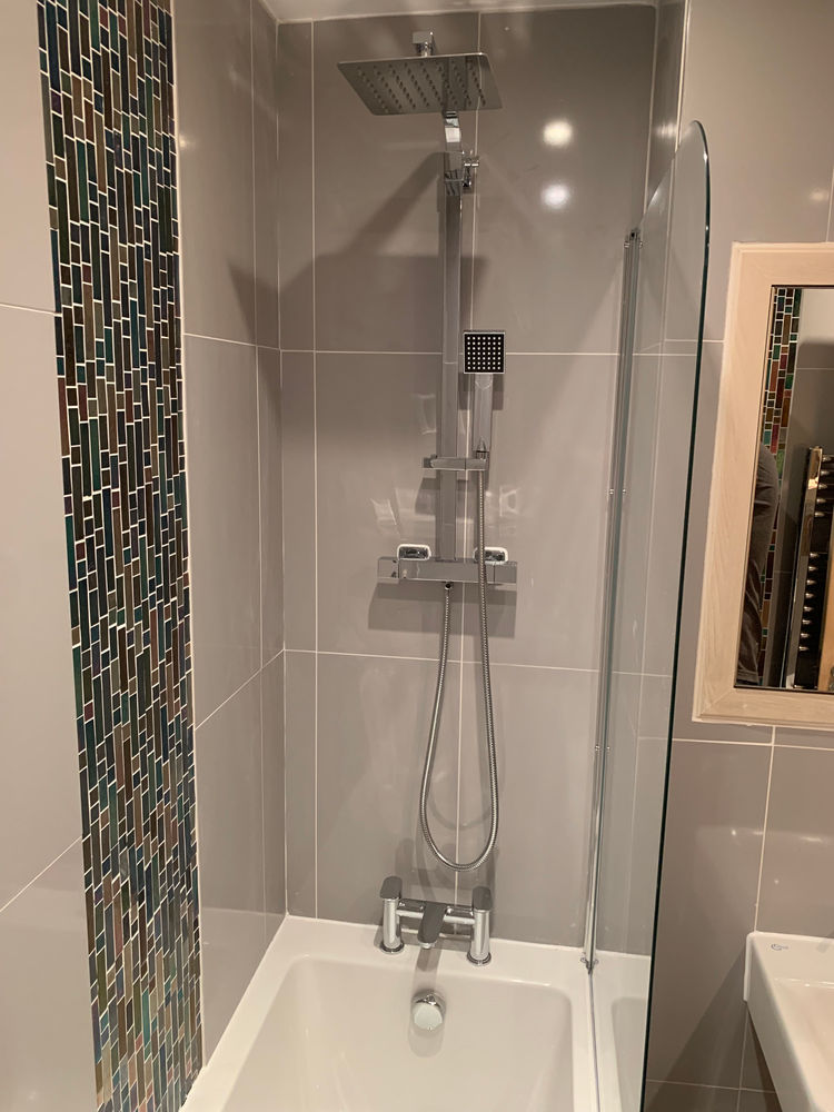 Modern shower fitting installed over bath